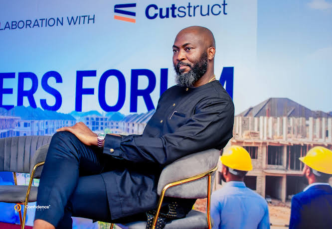 John Oamen seated on stage at a developers forum in collaboration with Cutstruct